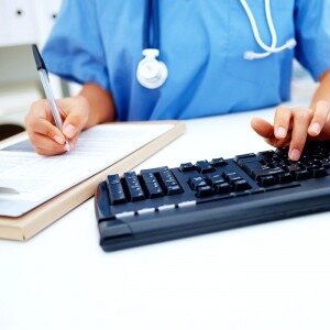 Medical person typing on keyboard